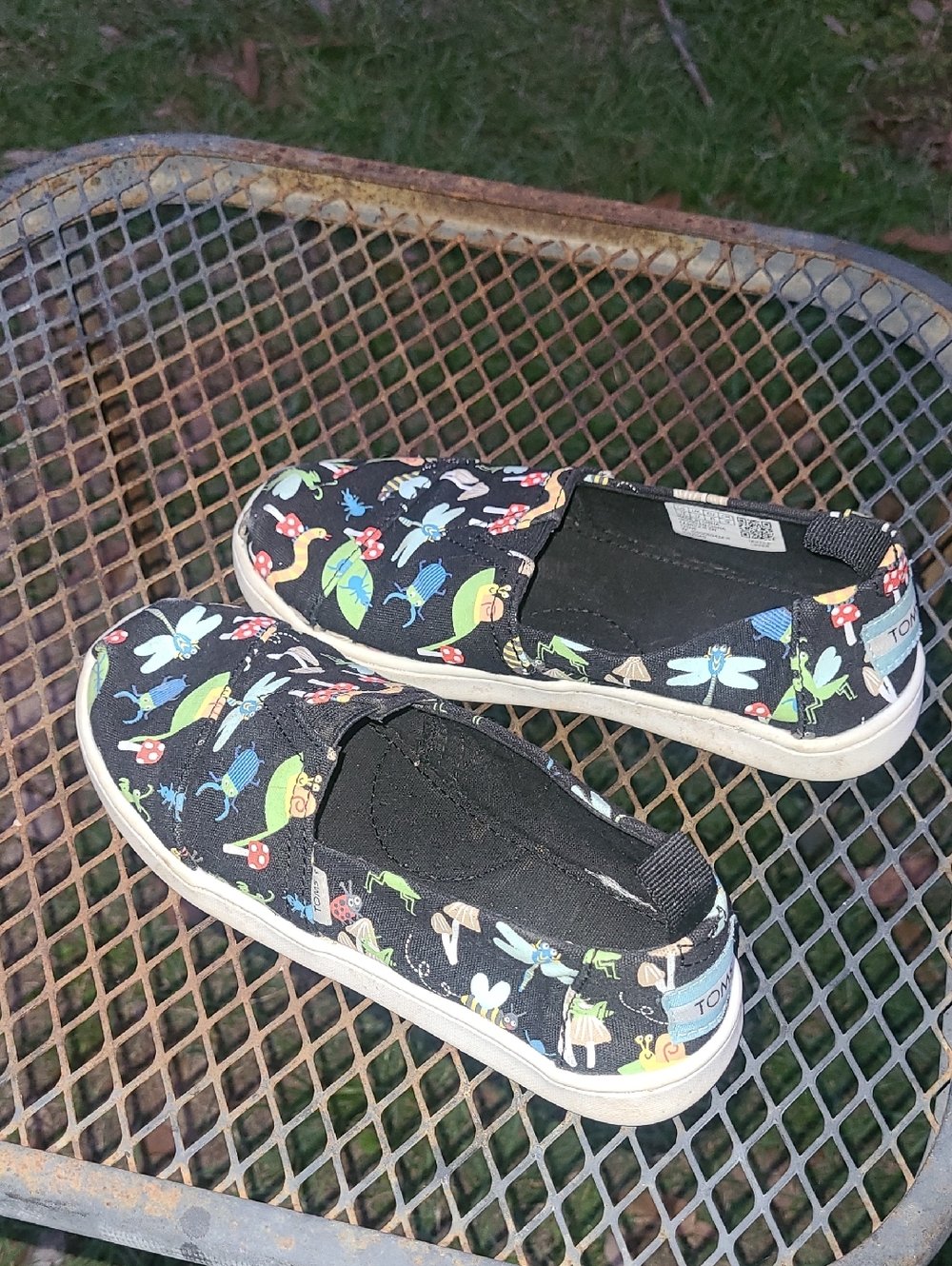 TOMS Kids Black Slip-On Sneakers with Multicolor Nature Bug Print